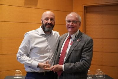 Gabriel Bosslet holds his award and poses with Dean Jay L. Hess