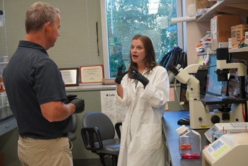 Melissa L. Fishel talking with a lab tour participant