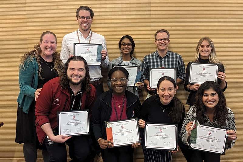 Dr. Jenny Baenziger with eight other people holding certificates