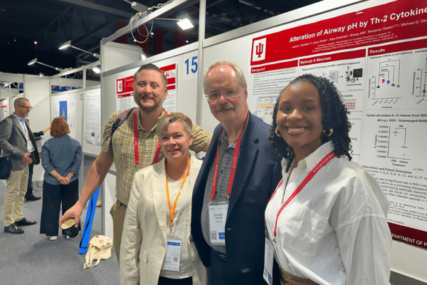 Members from the Gaston Laboratory huddled together in front of Ivana Daniels’ research poster at the European Respiratory Society (ERS) Congress in Vienna, Austria on September 9, 2024. From left to right: Michael Davis, PhD, Laura Smith, Benjamin Gaston, MD, and Ivana Daniels.