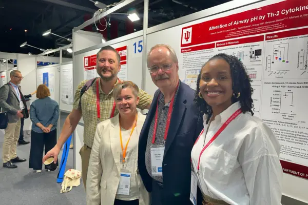 Members from the Gaston Laboratory huddled together in front of Ivana Daniels’ research poster at the European Respiratory Society (ERS) Congress in Vienna, Austria on September 9, 2024. From left to right: Michael Davis, PhD, Laura Smith, Benjamin Gaston, MD, and Ivana Daniels. 