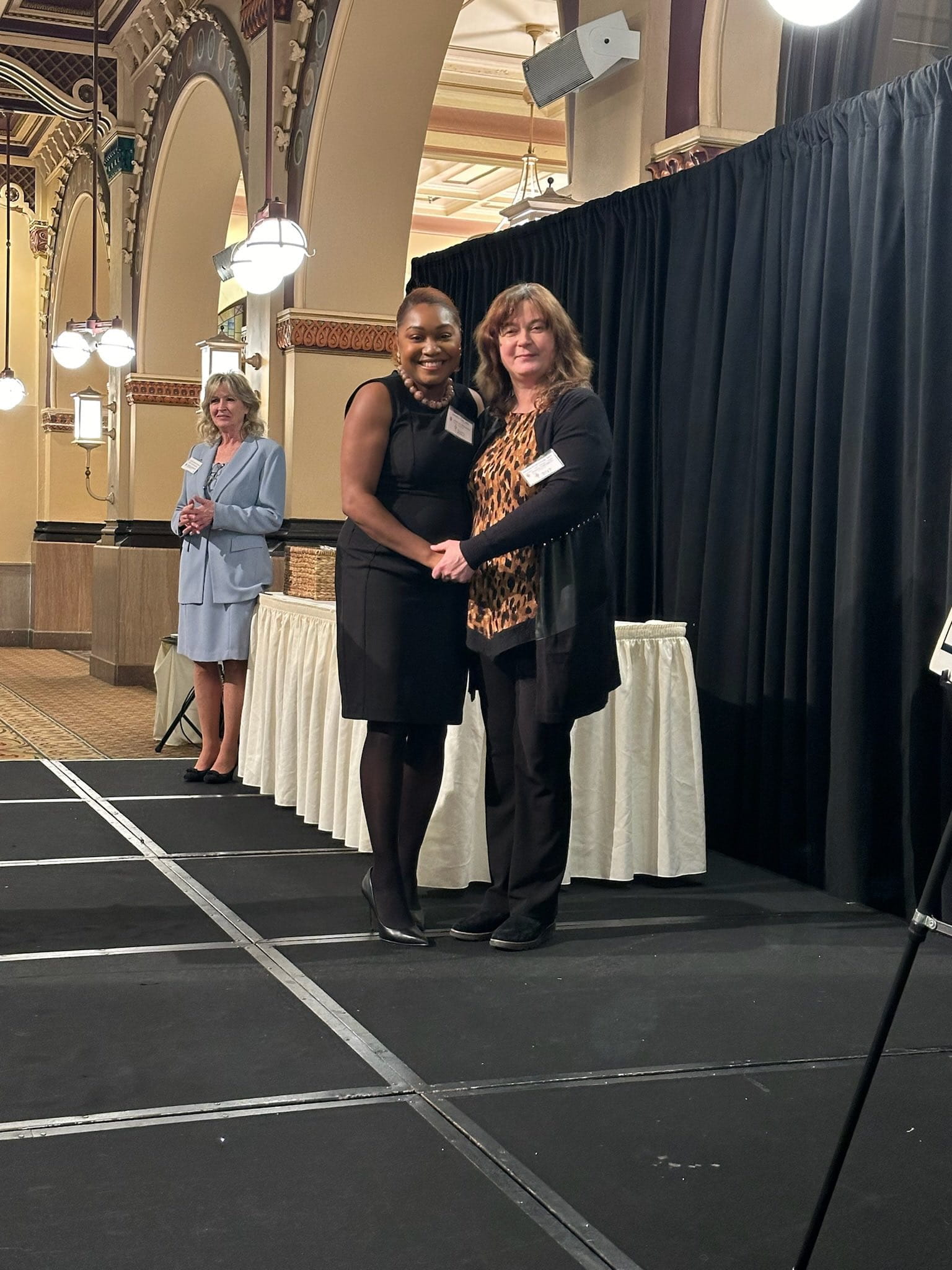 Dr. Jasmine Lee on stage accepting her induction into the AOA