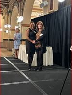 Dr. Jasmine Lee on stage accepting her induction into the AOA