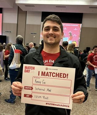 Kenneth Cox holds his Match Day sign.