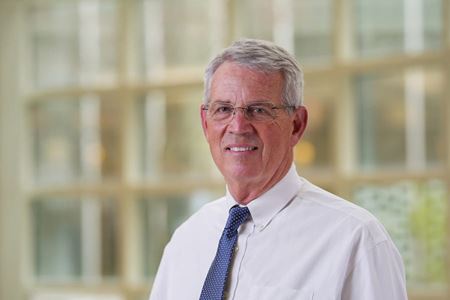 Portrait of Dr Mike Koch in white dress shirt and blue tie