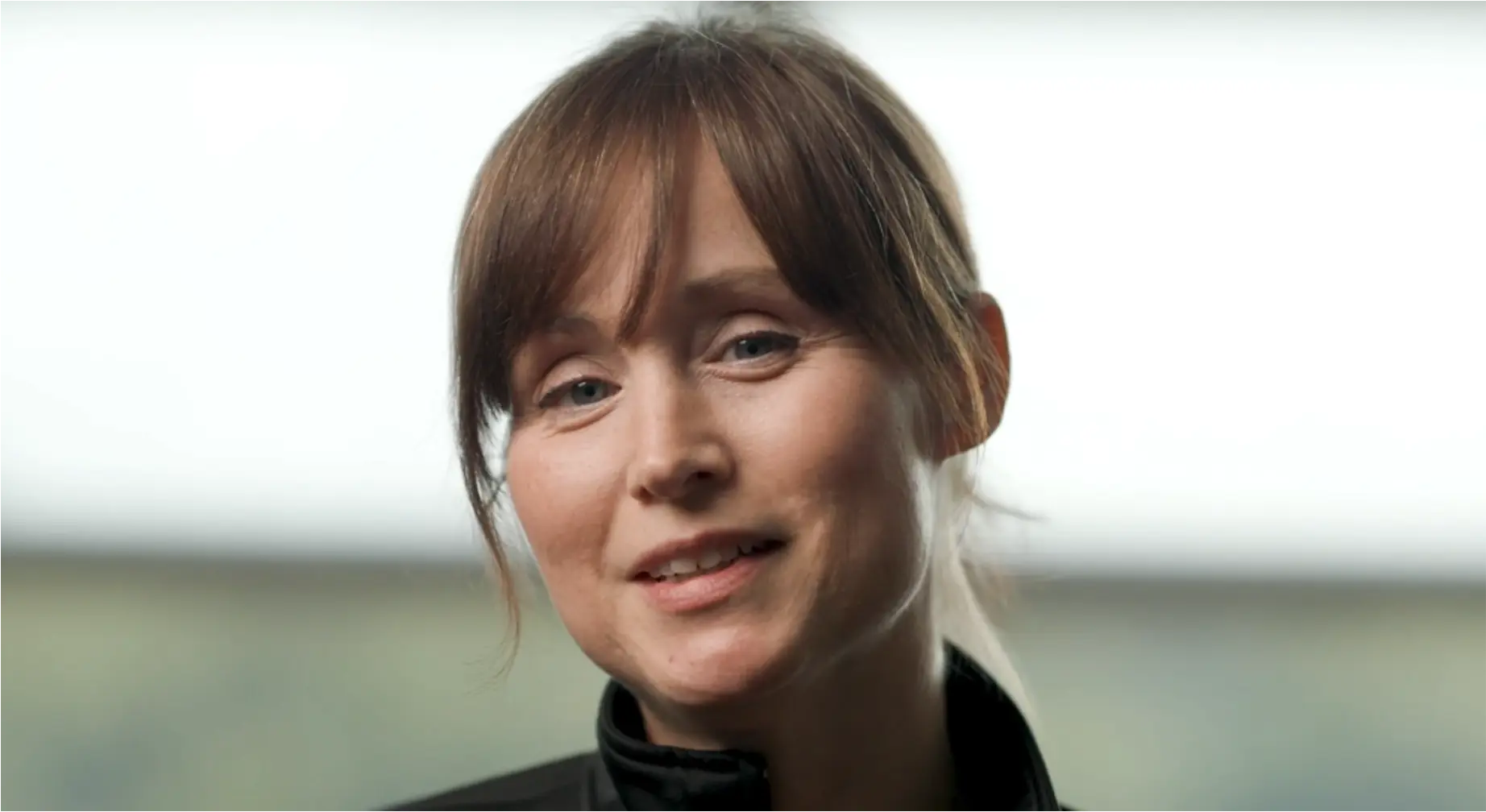 Video still of Dr. Kyra Reed in black turtle neck