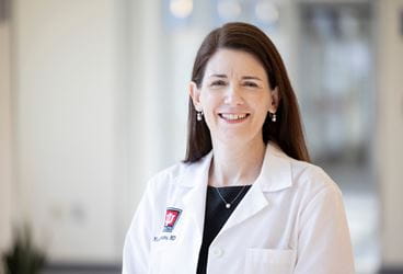 Michele Saysana in IU Health white coat, smiling