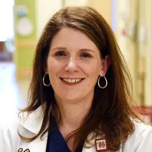 Michele Saysana headshot, smiling in white coat
