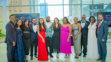 Zeina Nabhan stands at the center of a group of Multicultural Physicians Alliance leaders all dressed in formal attire for the 2024 gala.
