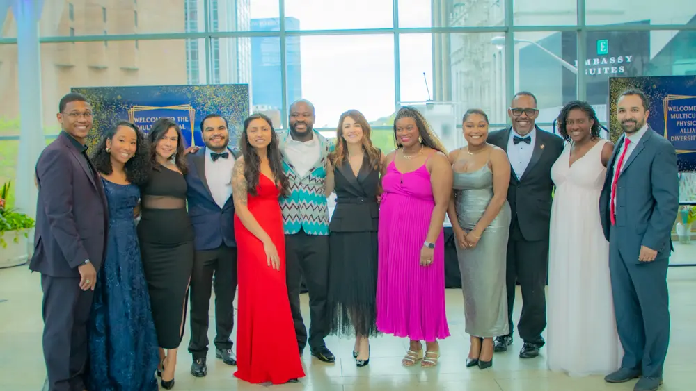 Zeina Nabhan stands at the center of a group of Multicultural Physicians Alliance leaders all dressed in formal attire for the 2024 gala.