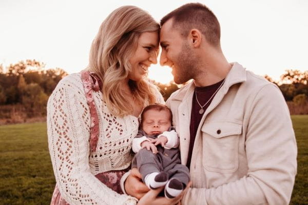 Luke Sartino, DO, with his wife and newborn son