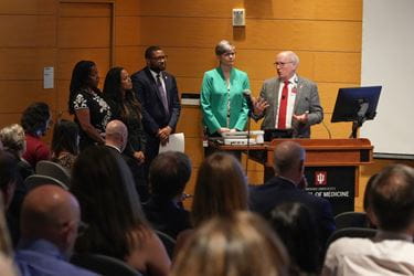 Dean Jay Hess and other IU School of Medicine leaders at front of room with crowd, answering questions at Spring 2024 All School Meeting.
