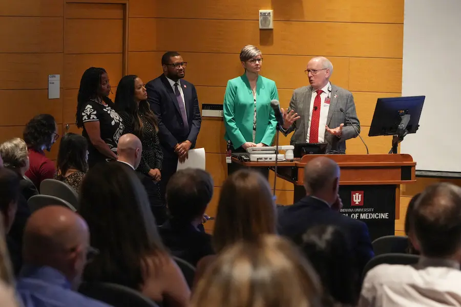 Dean Jay Hess and other IU School of Medicine leaders at front of room with crowd, answering questions at Spring 2024 All School Meeting.