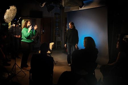 Krista Longtin (left) coaches 2024 Communicating Science participants during on-camera media interview practice at Cavanaugh Hall in March.