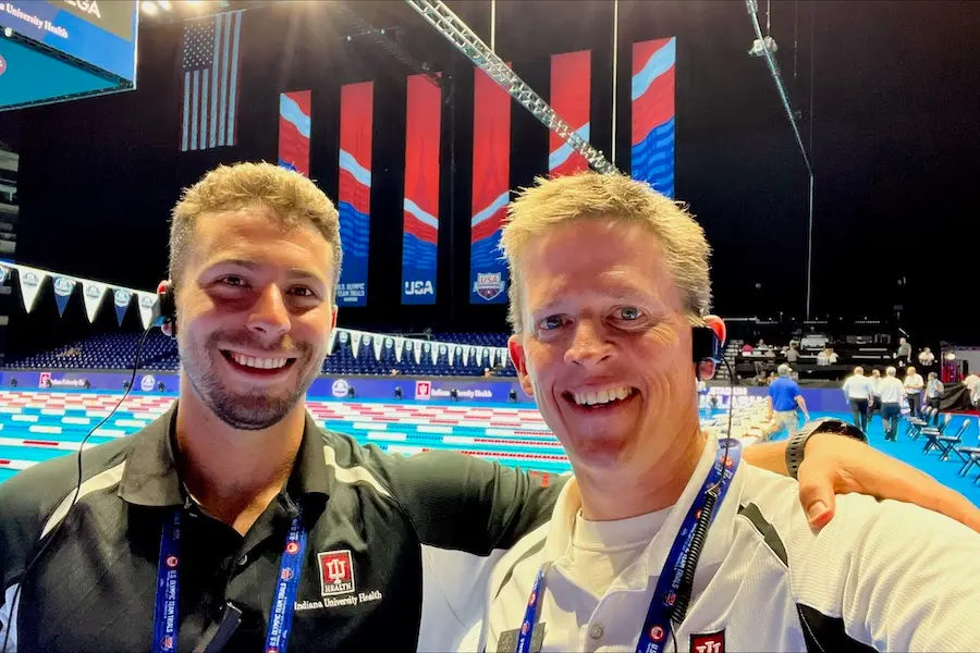 Dr. Zach Wagner and Dr. Stephen Hartsock poolside at Lucas Oil Stadium during a practice for the Olympic Trials in swimming.