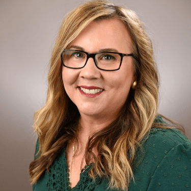 Headshot of Wendy Crandall, woman with long hair and glasses in green blouse