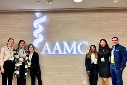 Gloria Xue (second from right) stands with members of the 2023-24 AAMC Organization of Student Representatives board in San Francisco. | Photo provided by Gloria Xue Gloria Xue poses with other Organization of Student Representatives leaders in front of a neon AAMC sign.