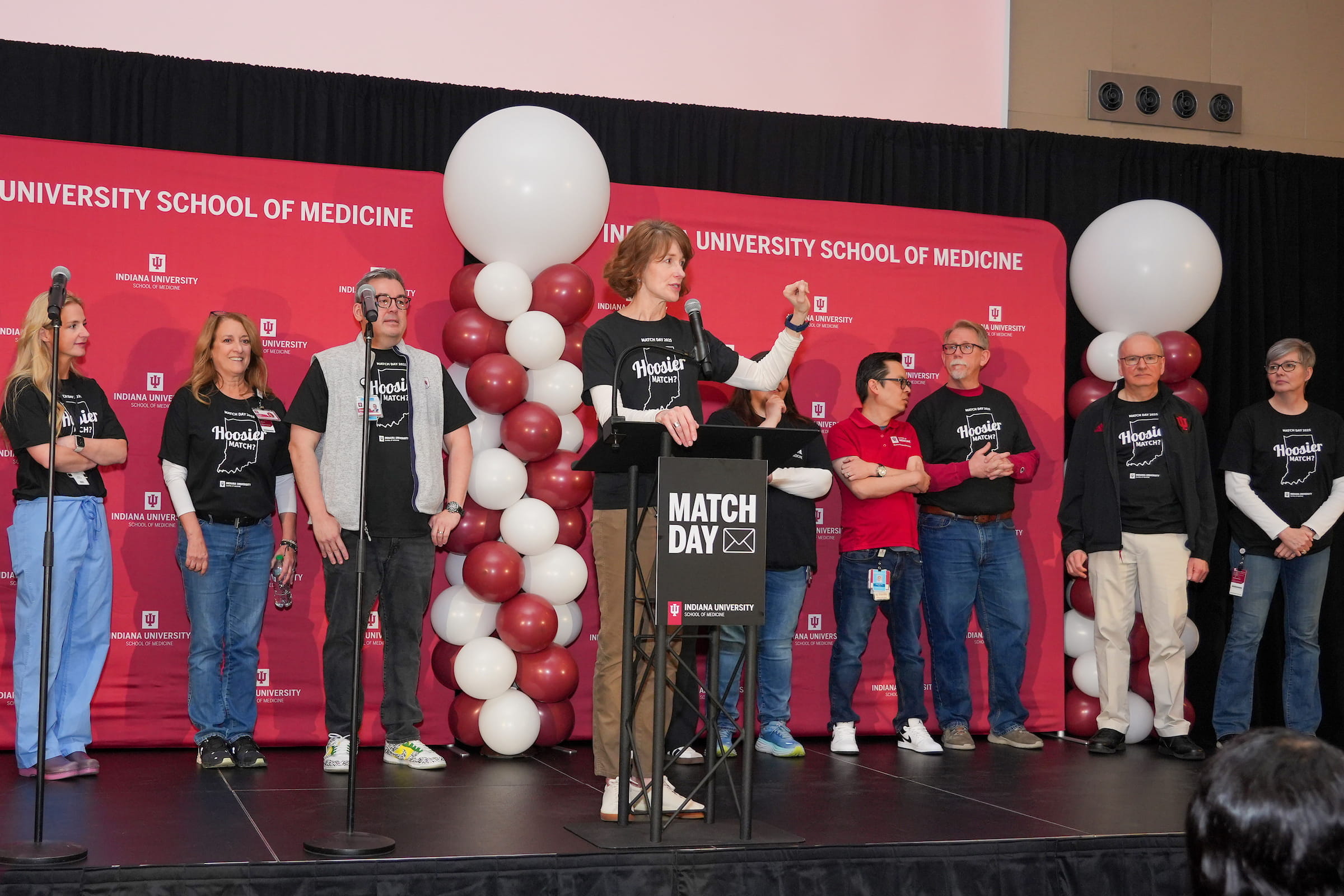 Emily Walvoord speaks at the podium during Match Day festivities