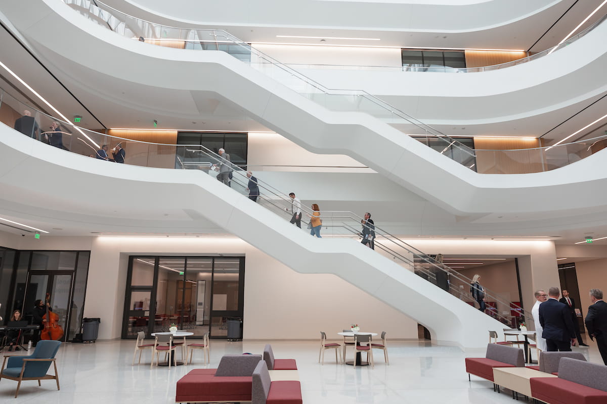 Medical Education and Research Building atrium with white staircases and people in the sunlight lobby