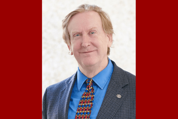 Headshot of Richard Gunderman on a red background.