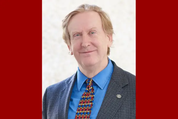 Headshot of Richard Gunderman on a red background.