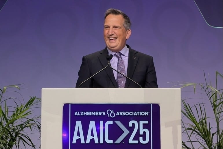 Bruce Lamb stands at a podium during the Alzheimer's Association International Conference