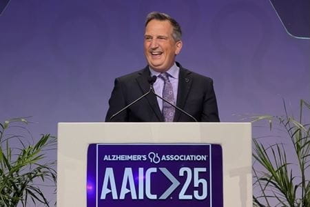 Bruce Lamb stands at a podium during the Alzheimer's Association International Conference