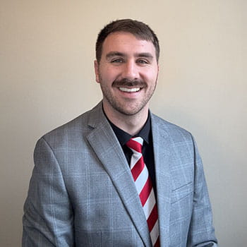 A photo of a man in a suit.