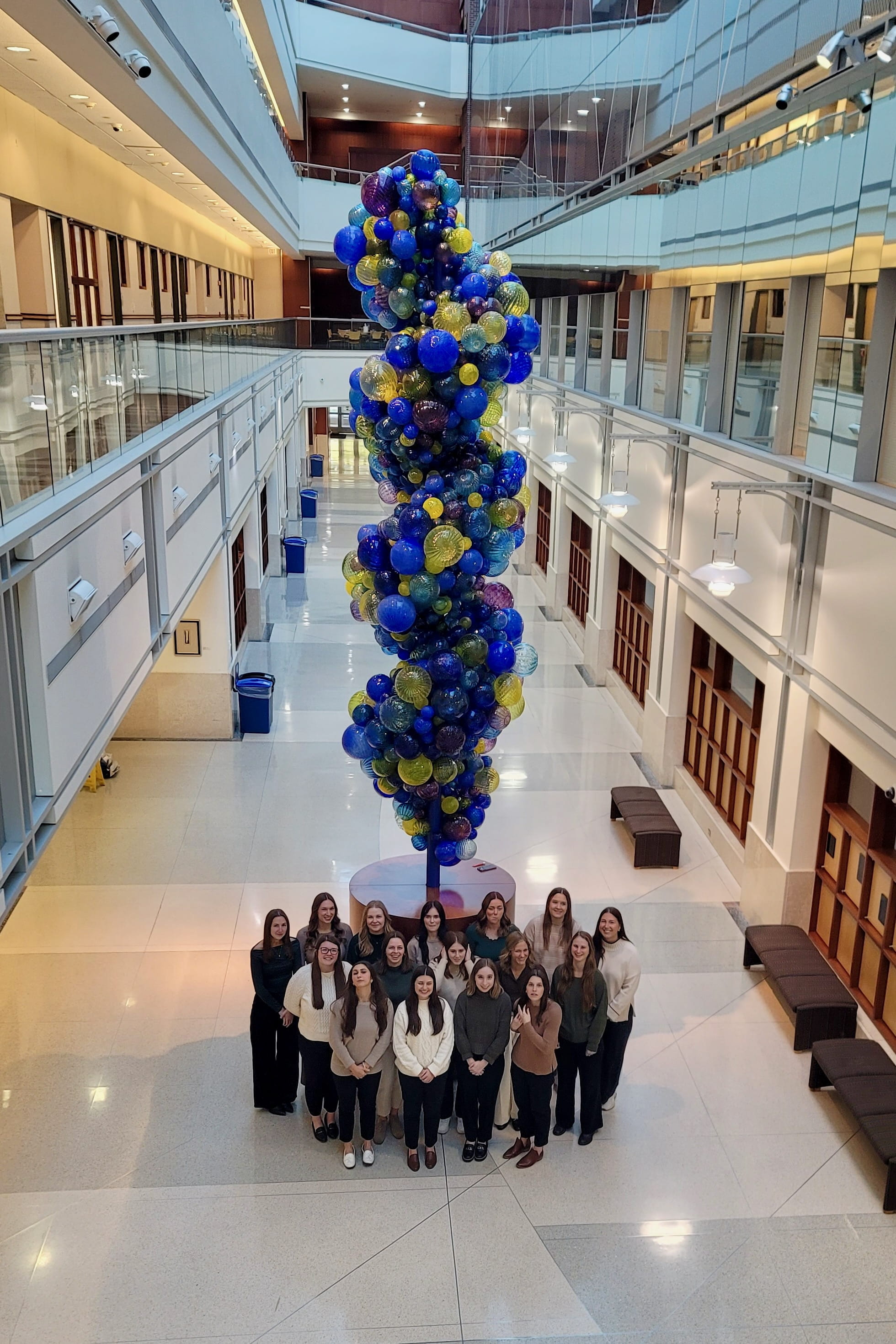 A group of students stands in front of the DNA Tower in the VanNuys Medical Science Building