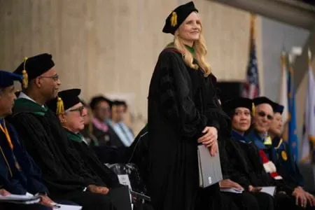 Laura Vater, in graduation regalia, speaks at the University of California San Diego Medical School commencement.