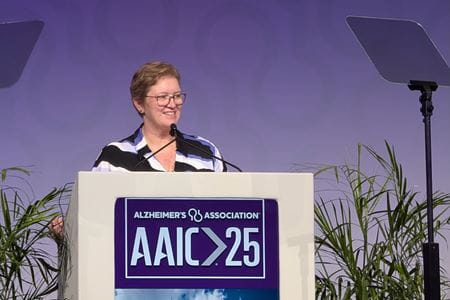 Donna Wilcock speaks at a podium during the 2025 Alzheimer's Association International Conference.