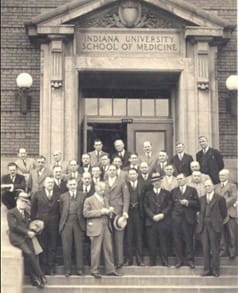 Photo of the otolaryngology course group featuring Dr. John Barnhill in the front looking down