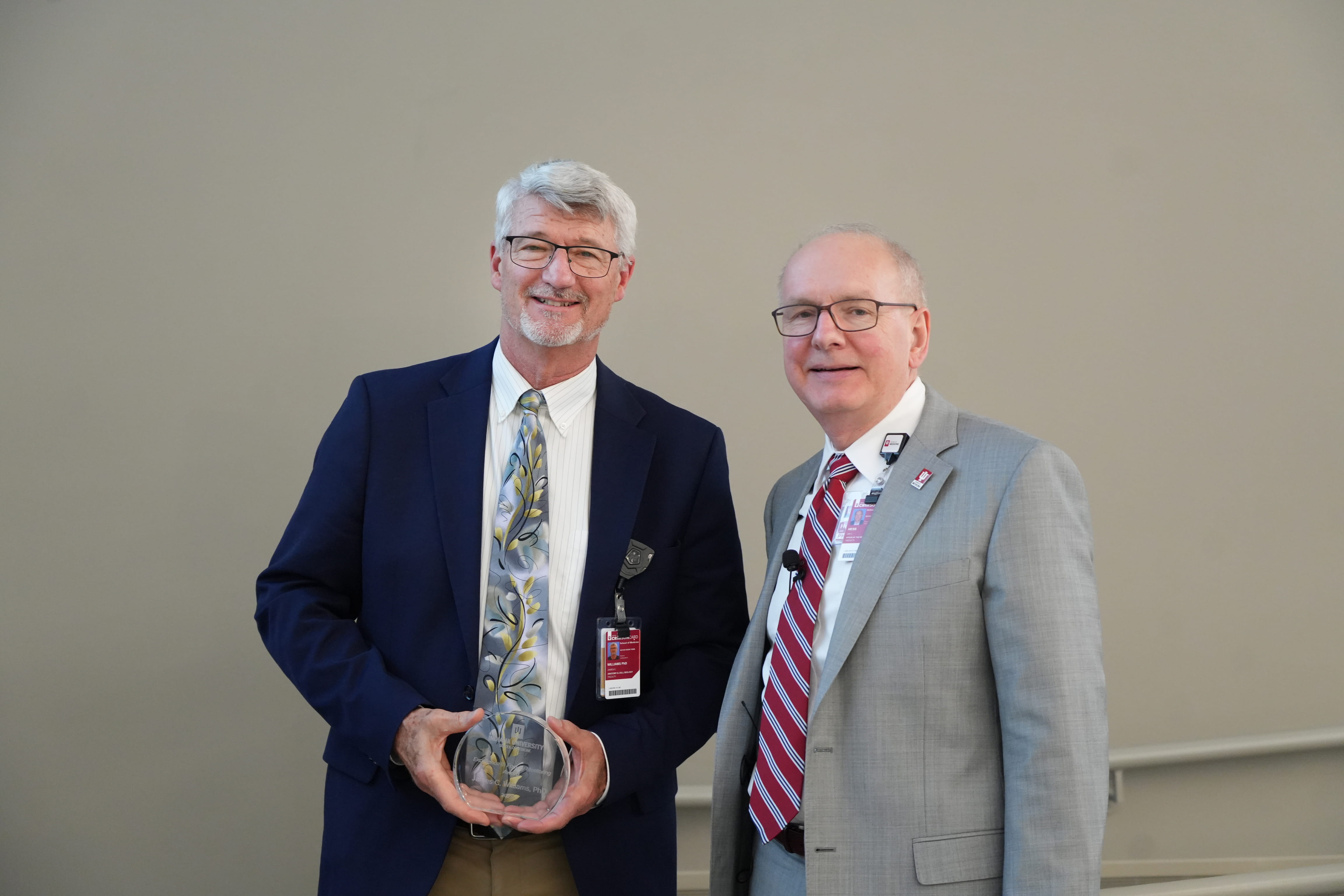 James Williams holds his award and stands with Dean Jay Hess 