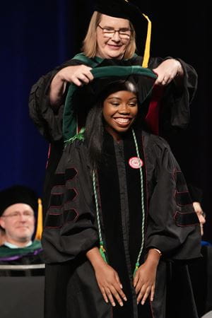 Okoruwa being hooded at the IU School of Medicine Graduate Recognition ceremony Okoruwa being hooded at commencement ceremony