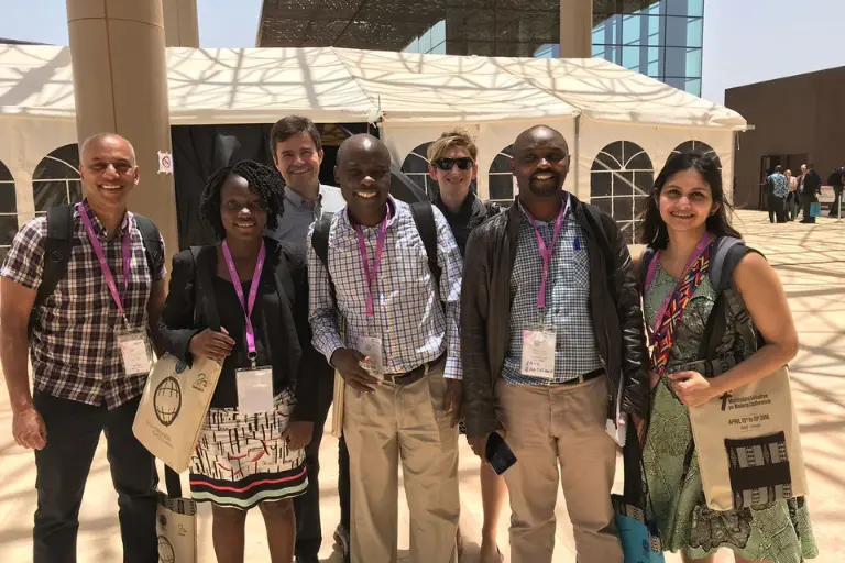 posed group photo of IU and Global Health Uganda scientists at the Pan-African Malaria Conference in Senegal in 2018