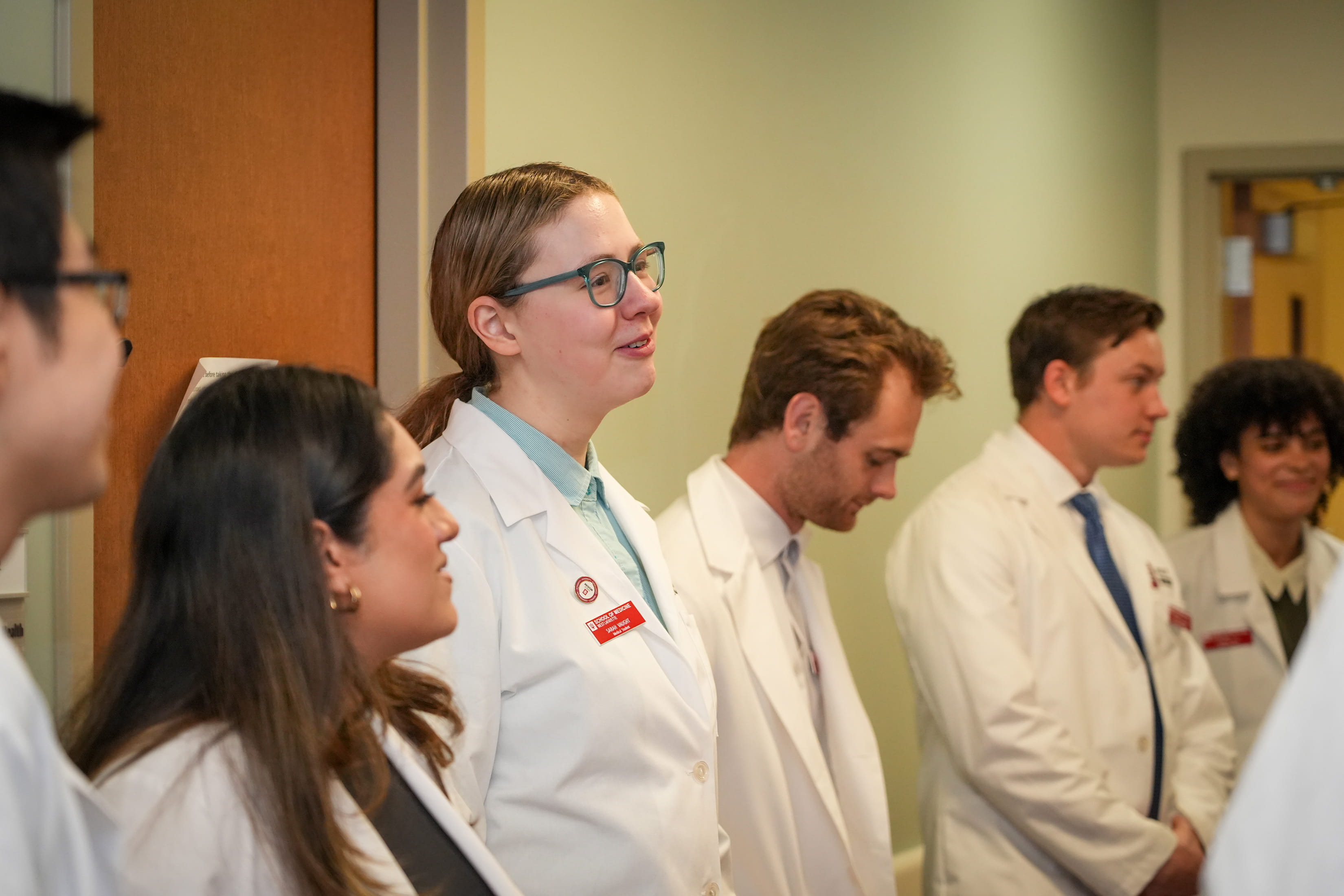 Sarah Vaught stands in a hallway with classmates at IU School of Medicine-West Lafayette. 