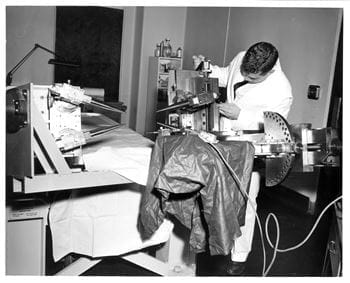 Technician prepares equipment in an operating room