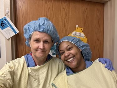 Lisa Landrum and Natasha Thompson wearing surgical garments