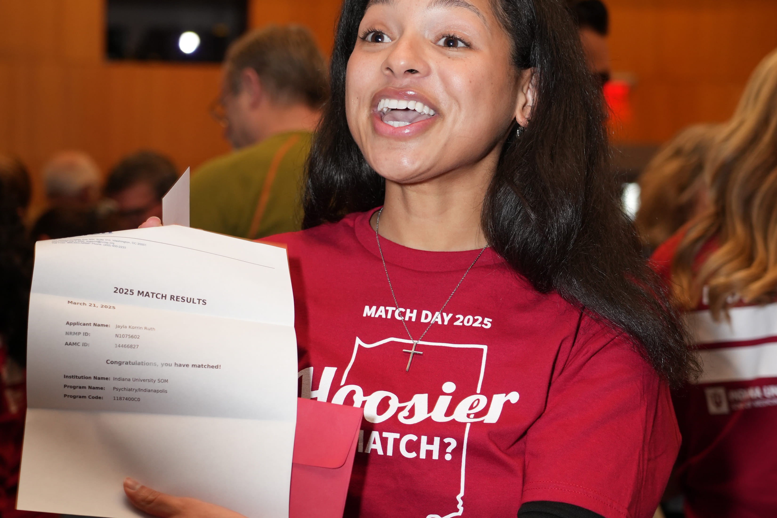 Jayla Ruth excitedly displays her Match Day letter indicating she will stay at IU School of Medicine for residency.