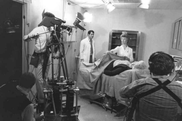 Black and white photo of a camera crew filming a medical video for IU's Medical Educational Resources Program