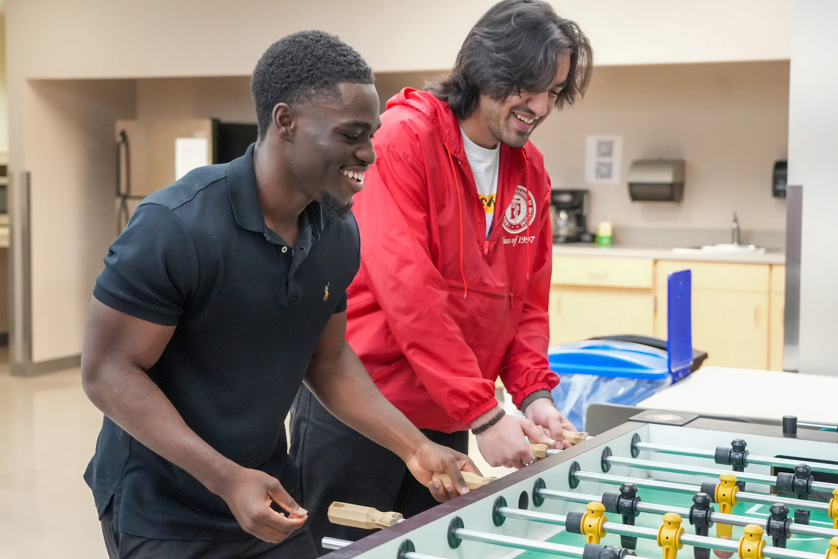 Mout-Maine Moustapha plays foosball with another student