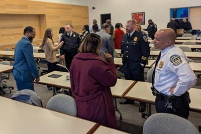 Lauren Magee discusses Non-Fatal Shooting and Advocacy Support Program preliminary findings with the IMPD and other local community leaders and gun violence advocates at an event in March 2025. | Photo courtesy of Lauren Magee, IU School of Medicine. Community members and IMPD officers interacting at a presentation event in March 2025.