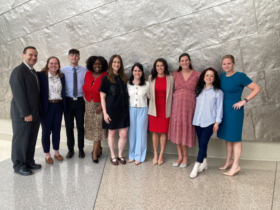 David Haas, MD joins OB-GYN presenting residents for a photo outside the auditorium during the 2025 Research Day. 