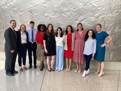 David Haas, MD joins OB-GYN presenting residents for a photo outside the auditorium during the 2025 Research Day.