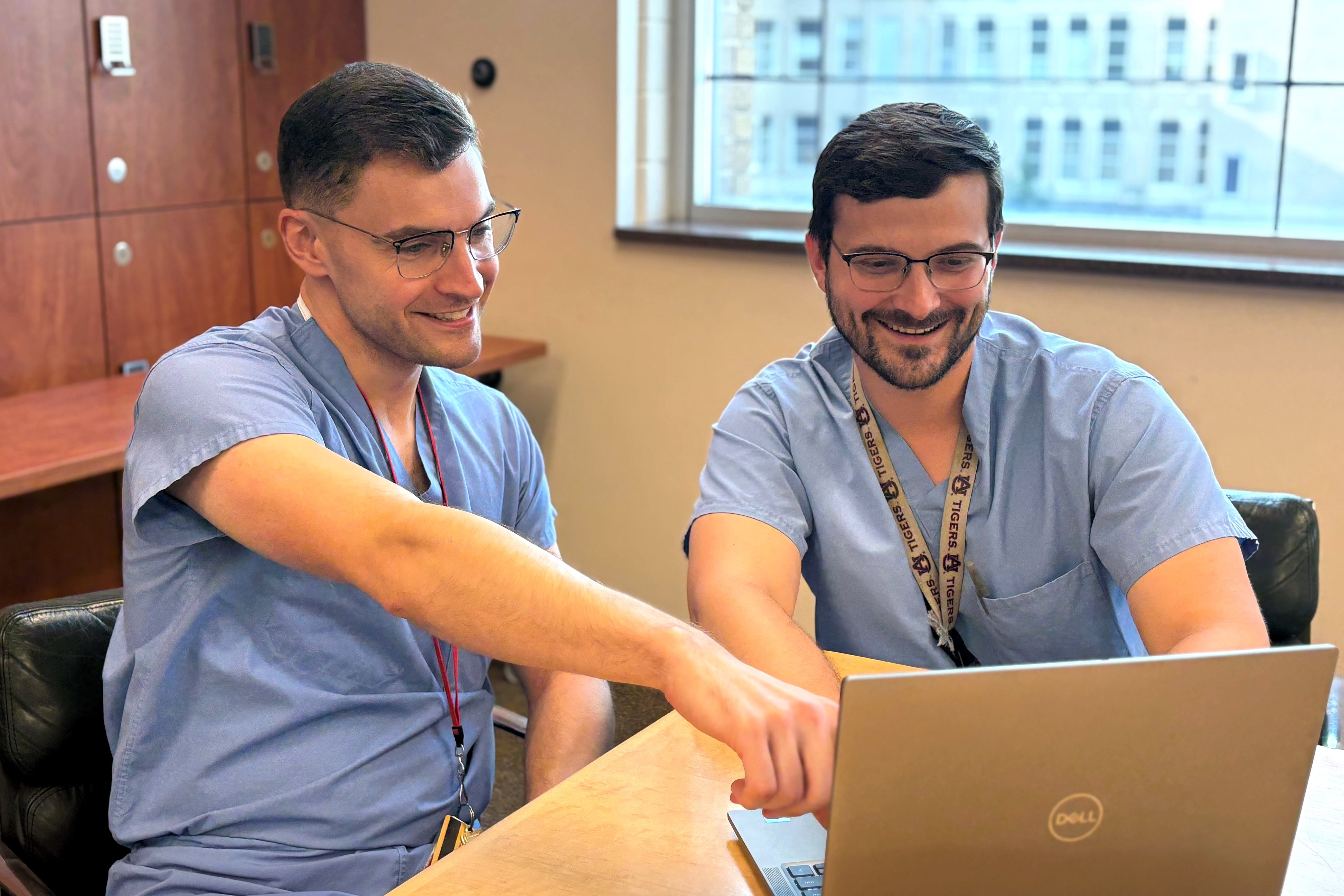 Two physician working together at laptop computer