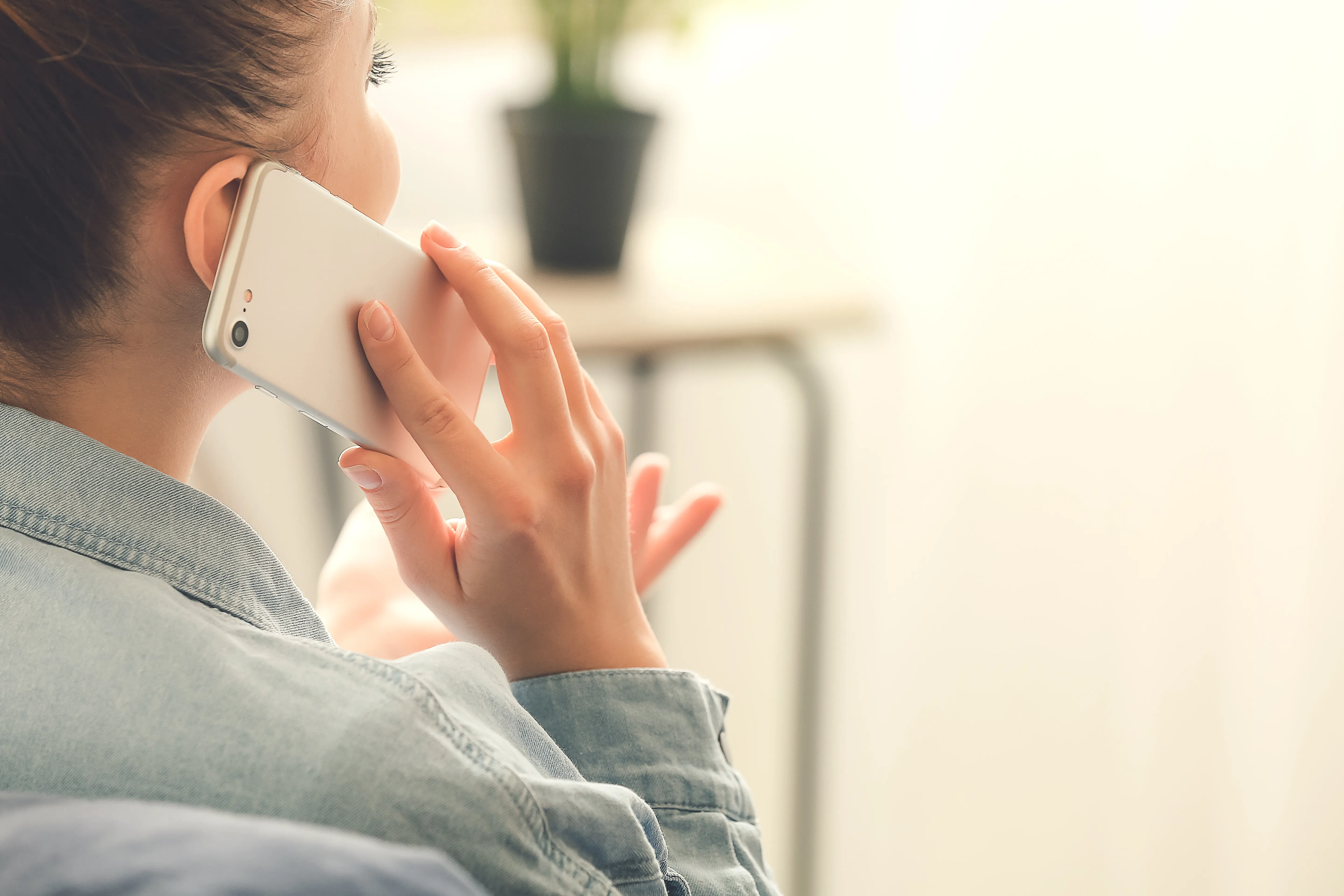 woman holding phone up to ear talking