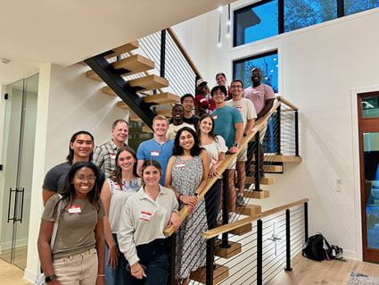 Mout-Maine Moustapha and other first-year medical students pose for a photo on a stairway at their PLC mentor's home.