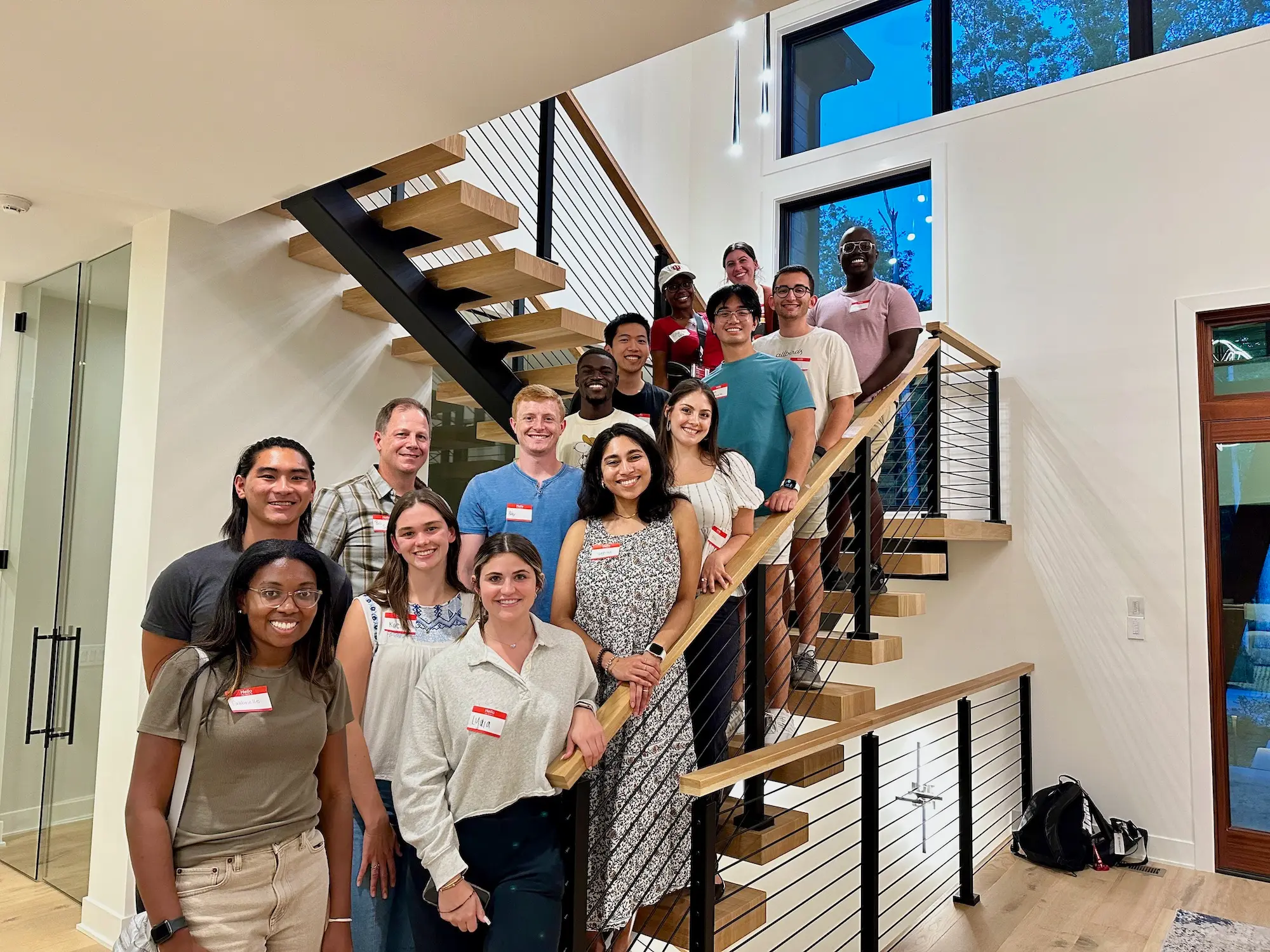 Mout-Maine Moustapha and other first-year medical students pose for a photo on a stairway at their PLC mentor's home. 