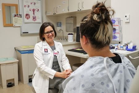 Sharon E. Robertson, MD, PhD, director of the gynecologic oncology fellowship program at Indiana University, consults with a patient.