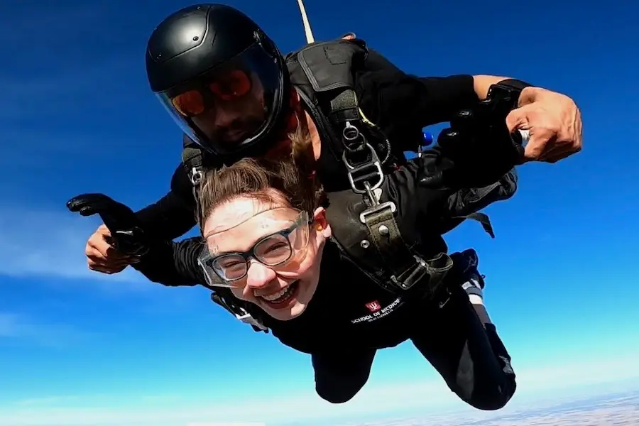 Sarah Vaught in air, during a tandem skydive, with a big smile on her face
